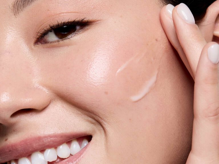 Woman applying Mary Kay Retinol 0.3 cream to her cheek