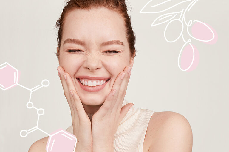 A woman smiles with her eyes closed and touches her face with both hands. Around her are illustrations of skincare product ingredients.
