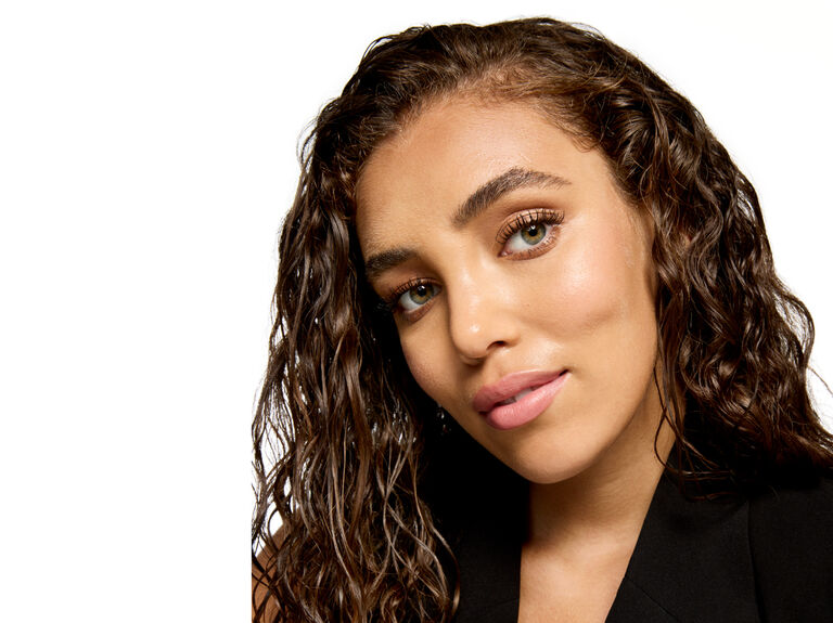 Woman with wet hair and skin looking at the camera
